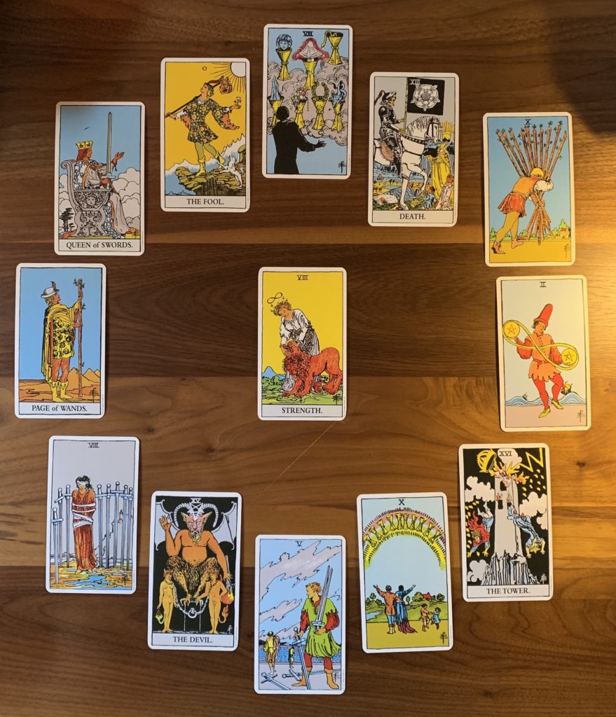 Twelve cards placed in a circle with a thirteenth card in the center. 